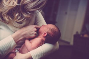 mother holding her baby in hands with joy